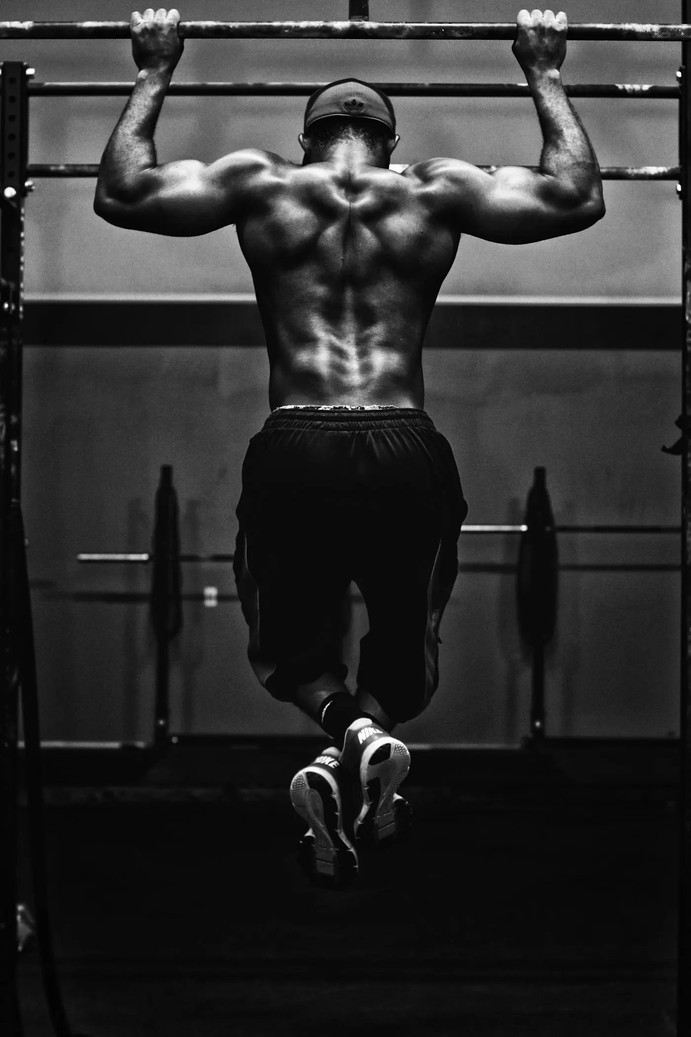 An athlete doing pull-ups in a gym