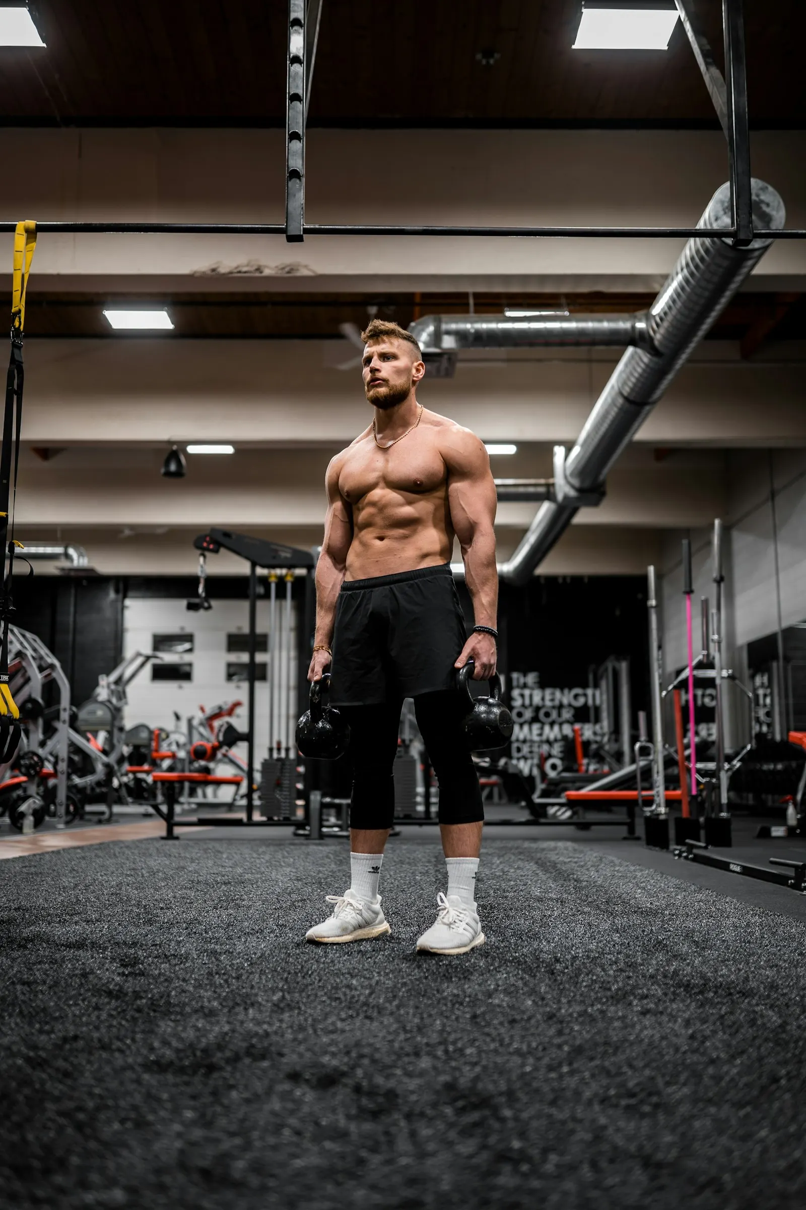 An athlete training with kettlebells in a gym
