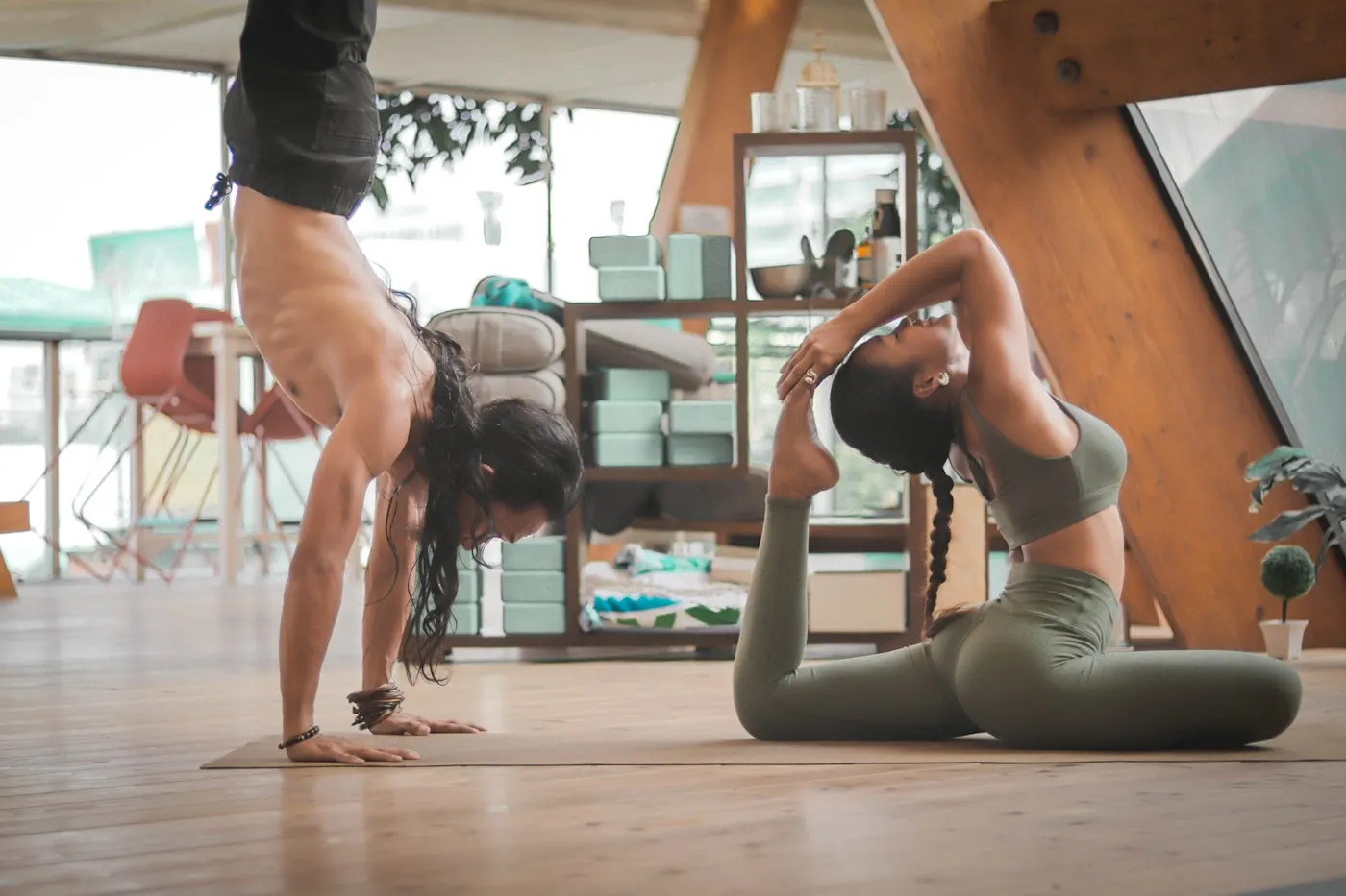 Two people performing mobility and stretching exercises